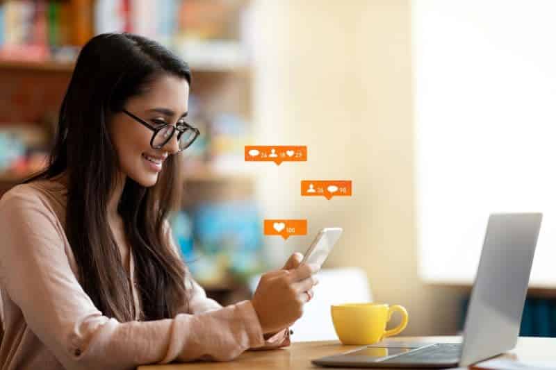 woman checking her engagements on social media