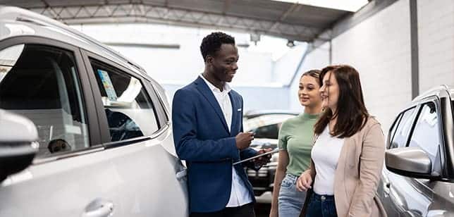 two ladies at a car dealership