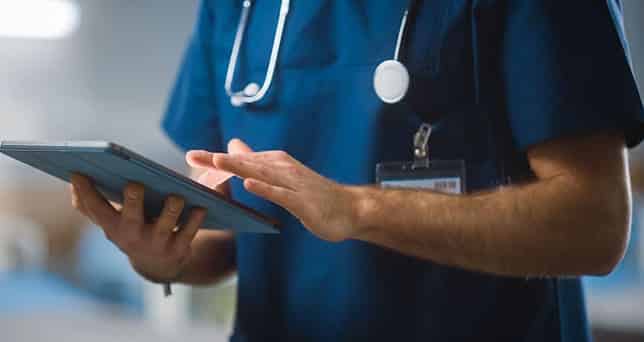 health care worker looking at a tablet