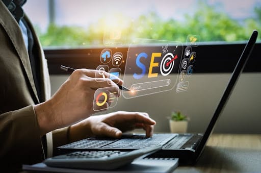 A professional working on a laptop with digital icons and the text 'SEO' displayed, symbolizing SEO for Lawyers.