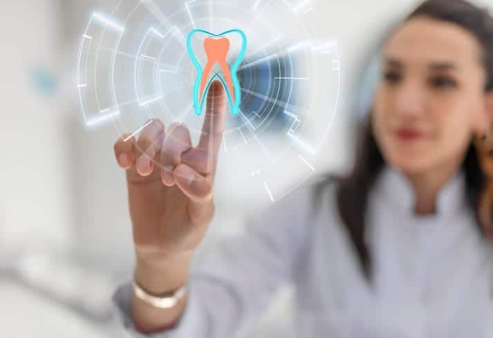 The concept of dental treatment as a woman clicks on a tooth icon.